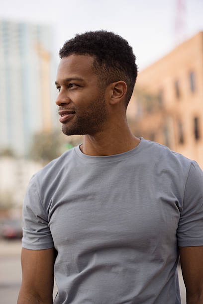 istock Young african american man smiling and looking away in urban setting 2206889920