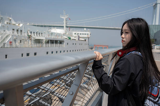 istock The female student watching the ship 2206890172