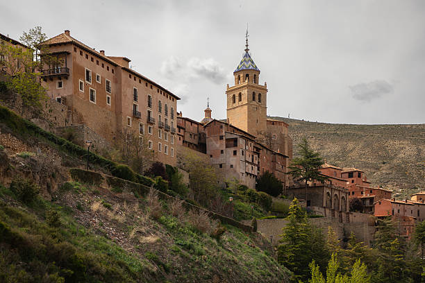 Albarracin, an ancient hillside town with a bell tower and mountains as a backdrop