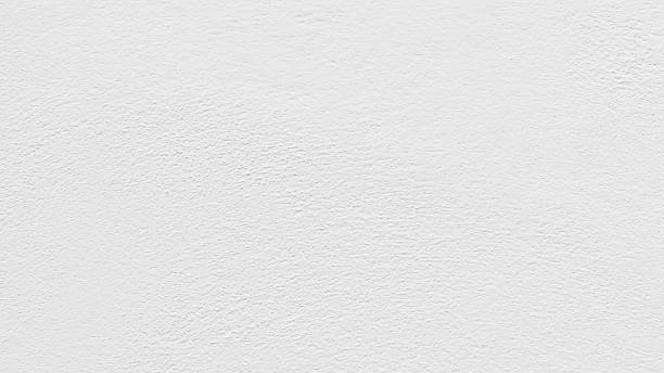 istock White concrete wall texture background. Uneven render stucco white painted concrete wall. 2206890631