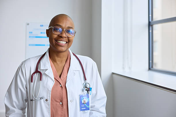 istock Smiling bald female doctor in white coat 2206891027