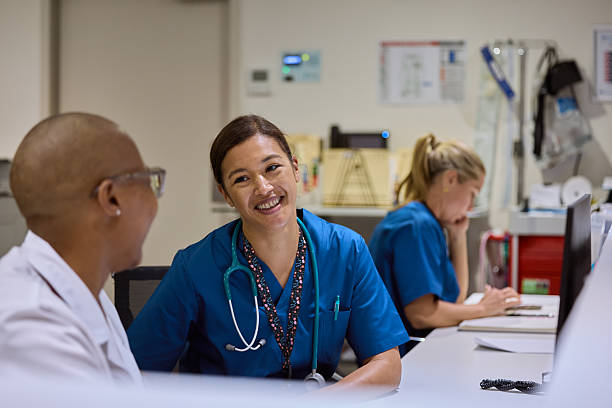istock Smiling female surgeon talking with doctor 2206891439