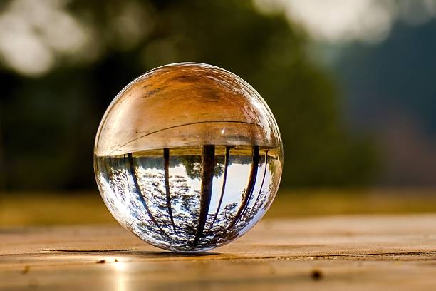 istock Glass ball on a table in the forest. Concept. Ecology. Selective focus. 2206892373