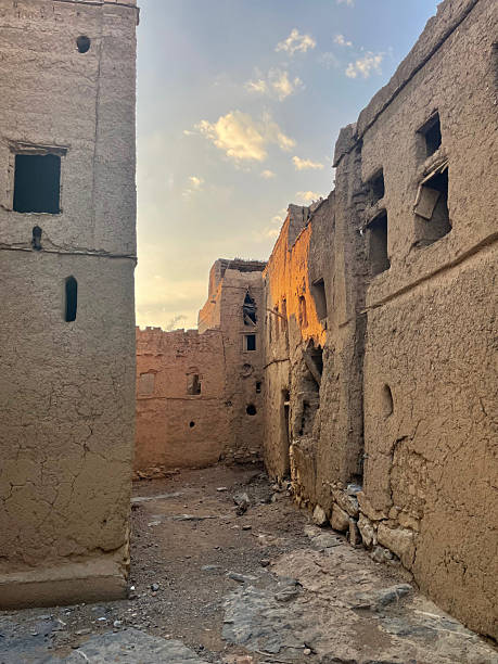 istock Abandoned Mud Brick Buildings in Al Hamra, Oman Create a Mysterious Atmosphere as Sunlight Illuminates the Deserted Alleyway 2206894905