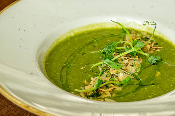 istock Close-up of green vegetable soup with almonds and microgreens 2206896508