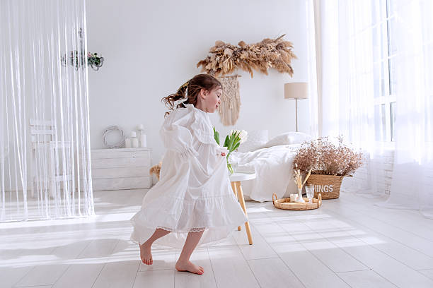 istock Happy child running in white bohemian bedroom playing 2206899128
