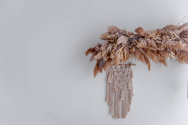istock Dried flowers and macrame wall hanging creating cozy bohemian interior 2206900009