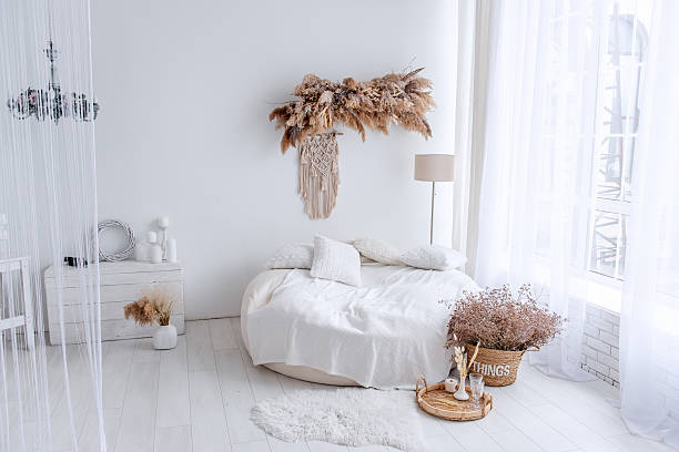 istock Round bed with macrame and dried plants creating cozy bohemian interior design 2206900164