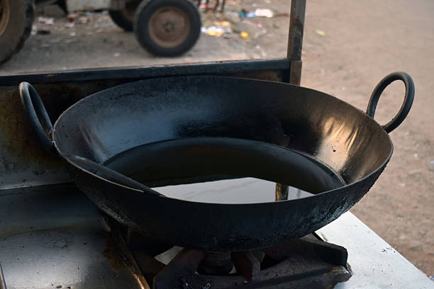 Big pan is heated for cooking and olive oil is poured on it