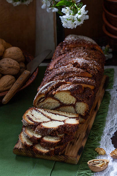 istock Traditional Easter bread with chocolate and nut filling on a wooden background. 2206905672