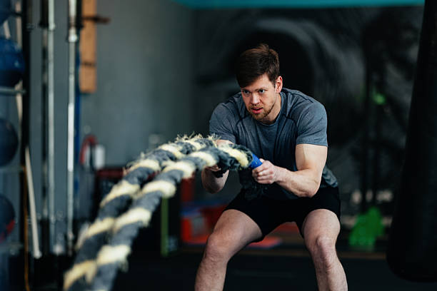 istock Determined Male Athlete Training With Battle Ropes in a Gym Setting 2206907313