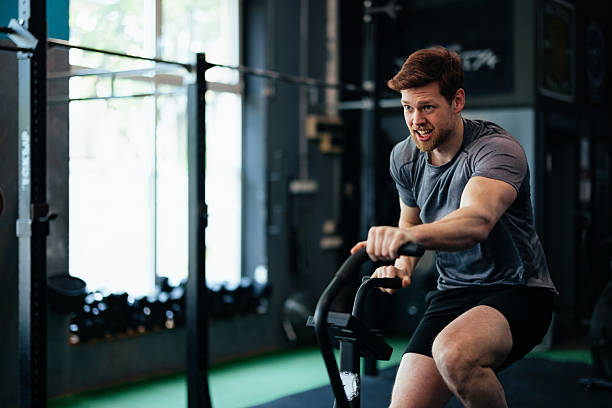 istock Man on a Cardio Bike Exercising in a Modern Gym Setting 2206907325