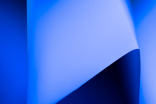 istock Wavy paper creates dynamic shapes with blue lighting in a creative setup 2206908712