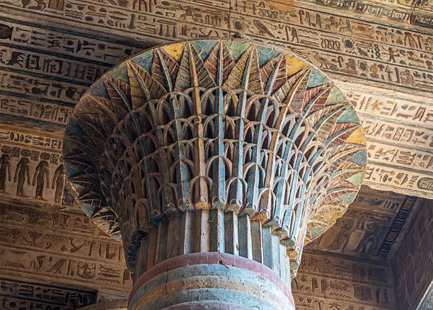 Detail of the imposing columns adorned with hieroglyphs stretch towards the ornate ceiling in Esna stock photo