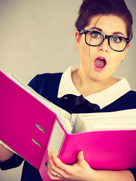 istock Shocked business woman looking at documents 2206912037