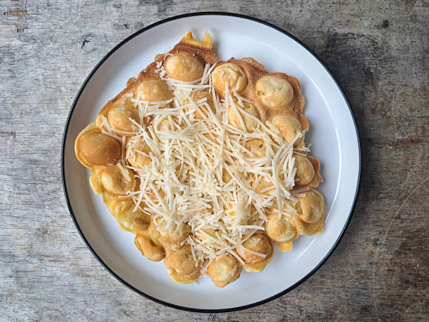 Traditional Lithuanian koldunai, small dumplings that come with a variety of fillings, server with sour cream. National Lithuanian cuisine.