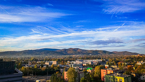 istock Mountains by day with city landscape 2206915489