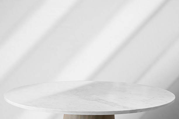 istock Round marble table top with abstract shadow drop on white wall background for mockup product display 2206918033