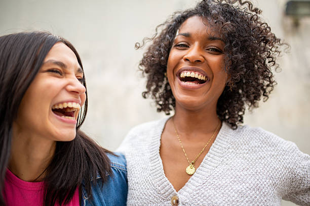 istock two women laughing together 2206918461
