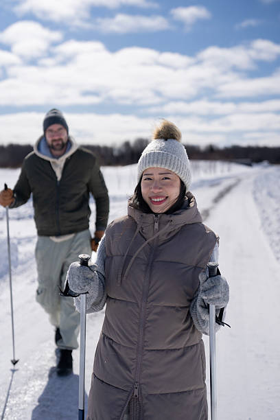 istock Two People Walking Together on a Snowy Path Under Clear Blue Sky 2206921499