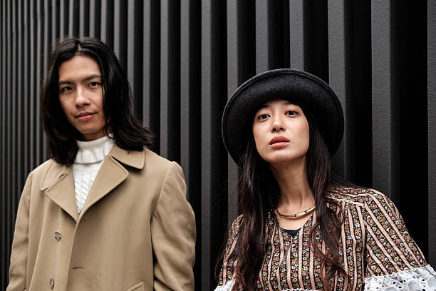 istock Fashionable couple posing against modern architecture 2206928374