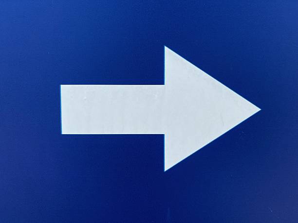 istock White arrow symbol on a blue background. 2206931106