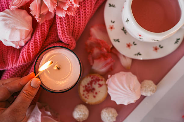 istock Flat lay with a cozy pink tea setting, meringues, candle being lit, tulips, and soft textures. Feminine and romantic atmosphere with sweet treats and warm ambiance 2206931427