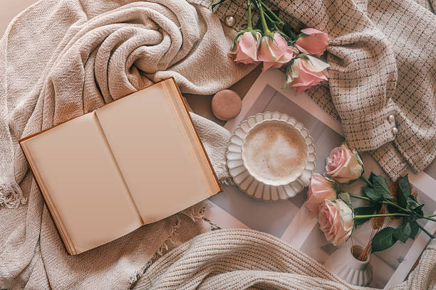 istock Flat lay with a blank open book, coffee cup, pink roses, and cozy beige fabric. Perfect for book mockups, journaling concepts, or minimalist lifestyle content with romantic tones 2206931471