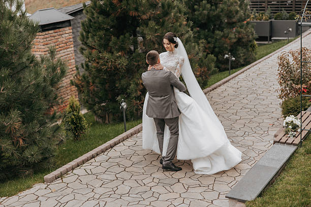 istock A bride and groom are dancing on a brick walkway 2206931895