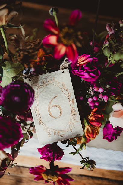 istock Close up of wedding reception dinner table with table number and flowers 2206936303