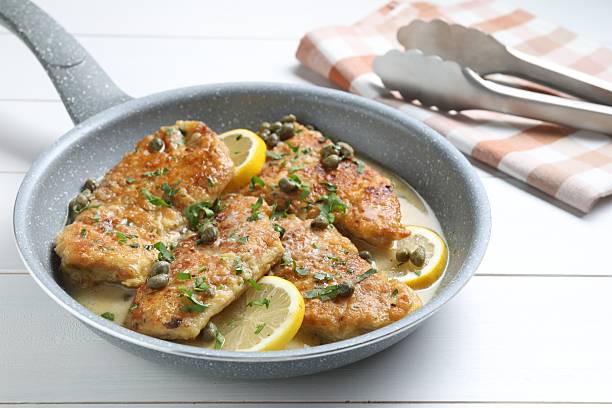 istock Delicious chicken piccata on white wooden table, closeup 2206937759