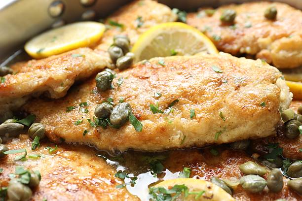 istock Delicious chicken piccata with herbs and lemons as background, closeup 2206937791