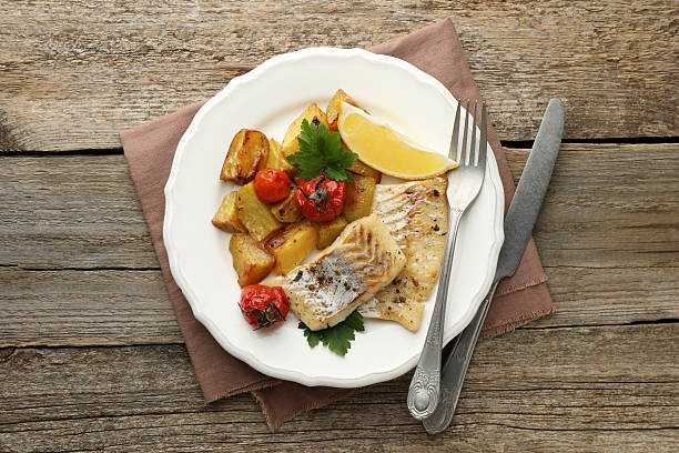 istock Tasty cod cooked with vegetables served on wooden table, flat lay 2206937902
