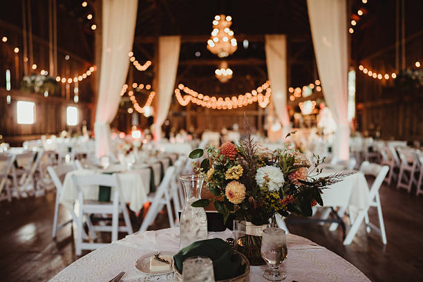 istock Wedding reception in barn with string lights and flowers 2206937932