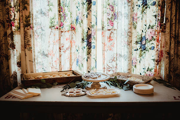 Dessert table at wedding reception with vintage floral curtains