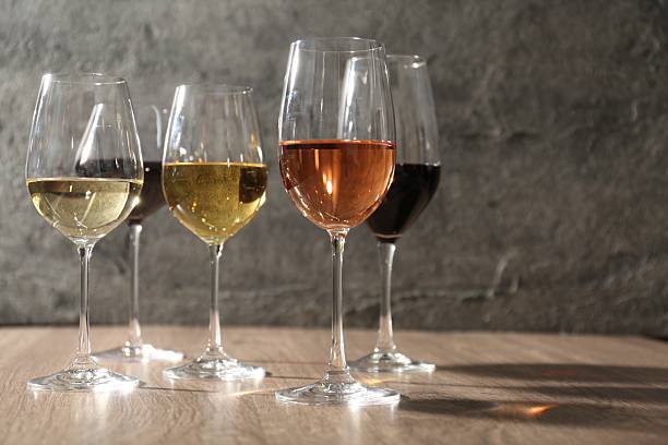 istock Different tasty wines in glasses on wooden table, space for text 2206940625