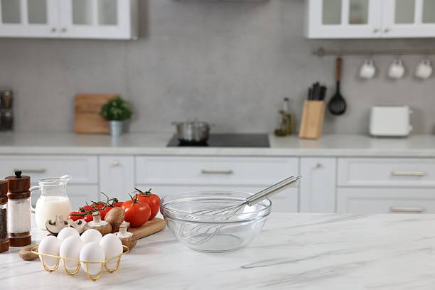 istock Whisk, bowl, and different ingredients on white marble table indoors, space for text 2206941030