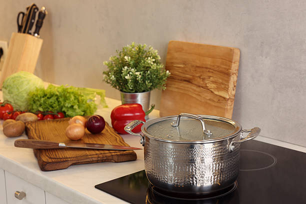 istock Cooking dinner. Pot and fresh vegetables on countertop in kitchen 2206941621