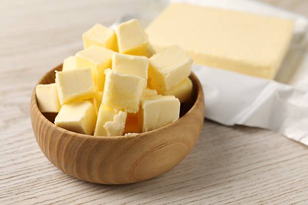 istock Tasty butter on light wooden table, closeup 2206941643