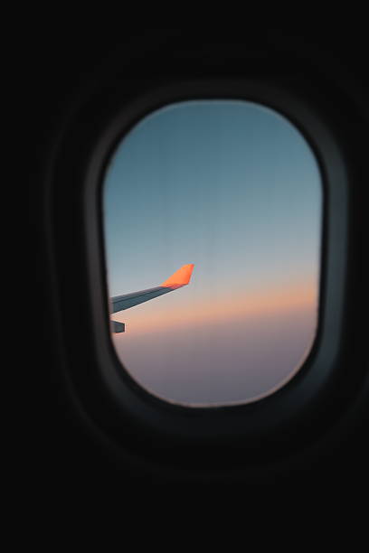 istock An Aircraft Wing is Captured Against a Beautiful Sunset Through the Passenger Window 2206945144