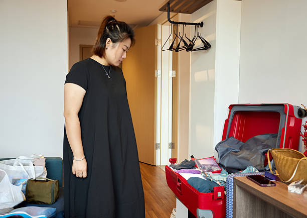 Woman packing suitcase for travel