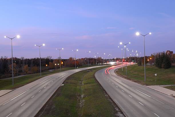 istock evening road light trails from cars, long exposure 2206947111