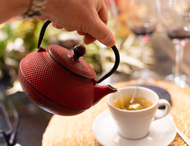 istock Pouring Tea from Red Teapot into Cup 2206947809
