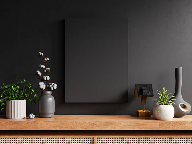 istock A mockup frame placed on a cabinet in a living room interior against an empty dark wall background- 3D rendering 2206948167