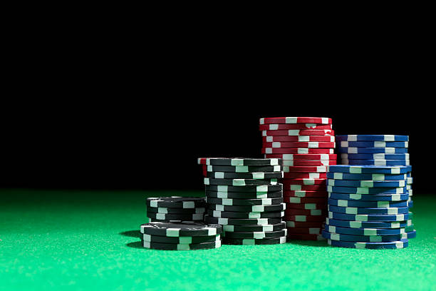 istock Stacks of poker chips on green table against dark background, space for text 2206950202