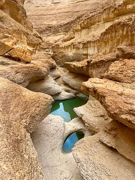 istock Eroded desert canyon with turquoise water pools and natural rock formations 2206951116