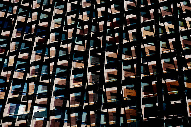 Closeup low angle view of modern corporate glass building, Sydney Darling Harbour, black and white, background with copy space, full frame horizontal composition