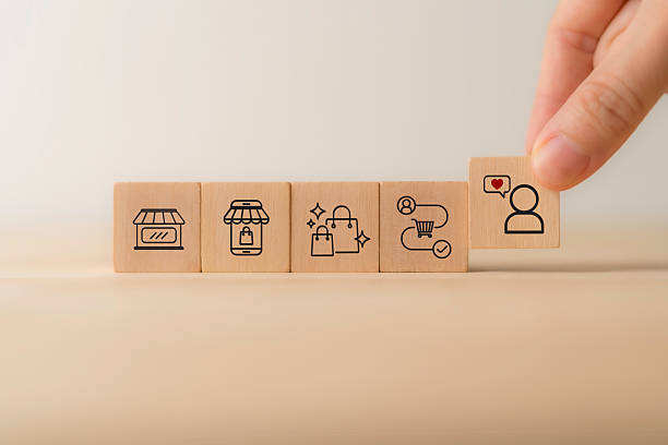 istock Seamless customer experience concept.  A close-up image of a hand selecting a wooden block with a customer icon and heart symbol, representing customer satisfaction, customer experience and engagement 2206956730