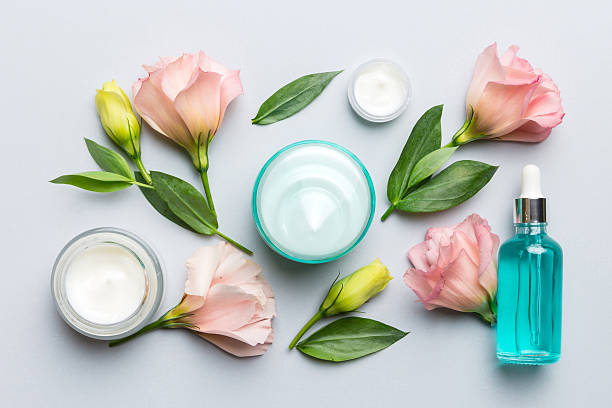 istock Composition with cosmetic products and beautiful roses on color background. Flat lay 2206956780
