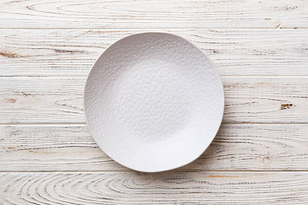 istock Top view of empty light plate on wooden background. Empty space for your design 2206956787